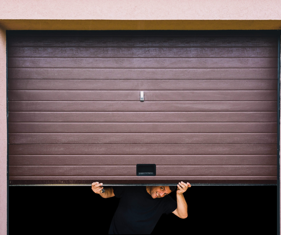 Person manually lifting a brown garage door from the bottom in Lakeside, CA.